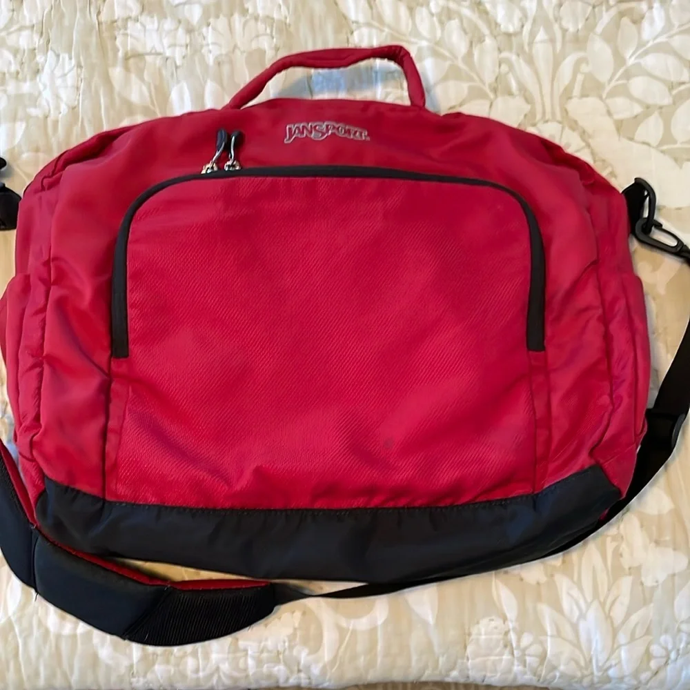 Red Jansport laptop messenger bag. Interior Velcro & outer zippered compartment